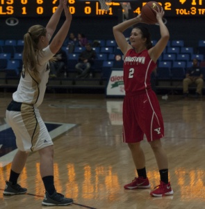 Photo by Dan Hiner/The Jambar. Youngstown State University guard Alison Smolinski looks to pass the ball in Monday night's loss to the University of Akron.